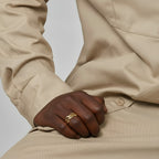 Champion of God gold crown of thorns ring on a hand, detailed braided design.