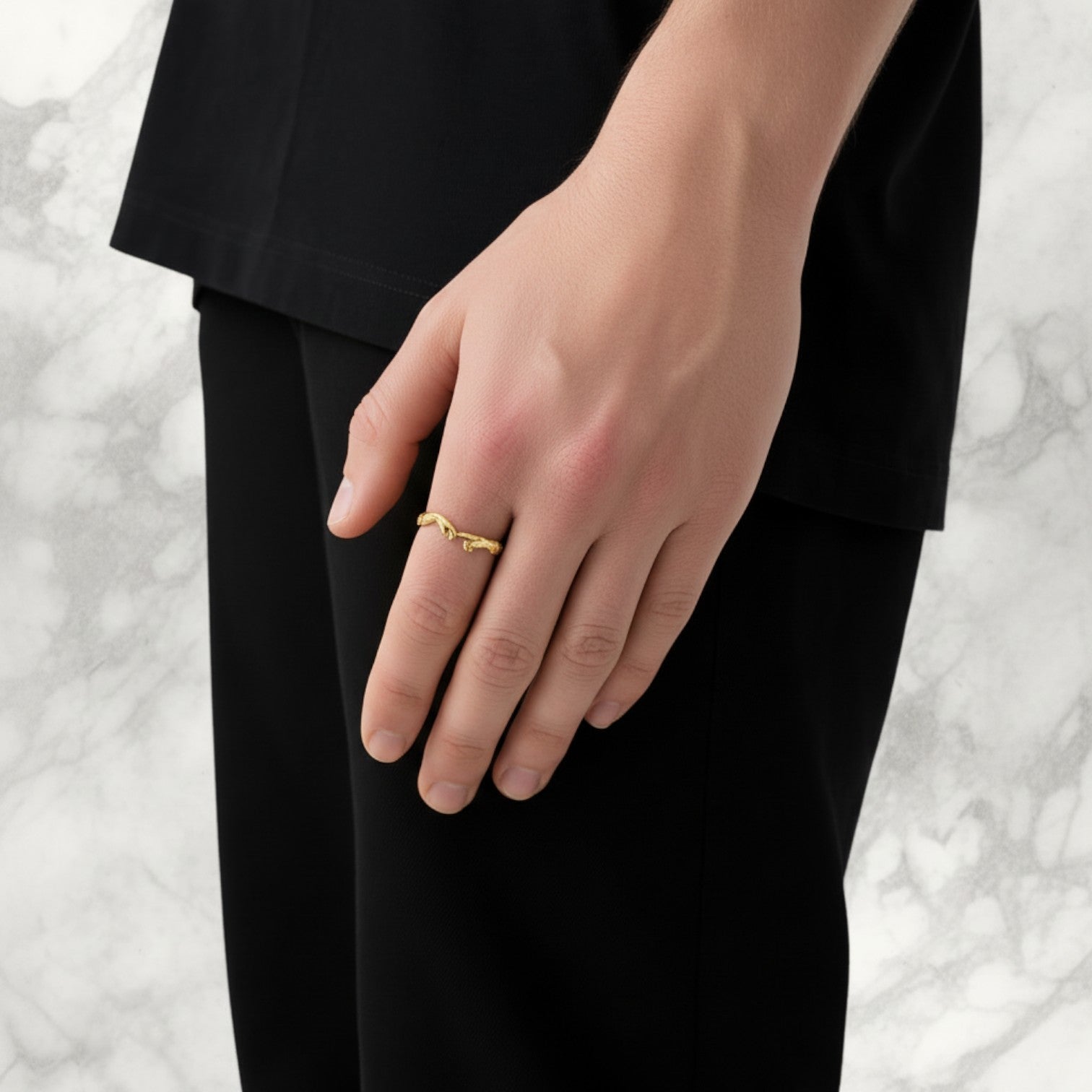 Championofgod gold ring designed as two hands reaching out, worn on a person's finger.