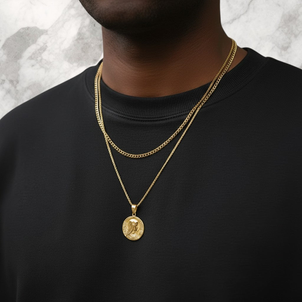 Championofgod Mother of God quarter necklace with gold chain layered over a black crewneck shirt.